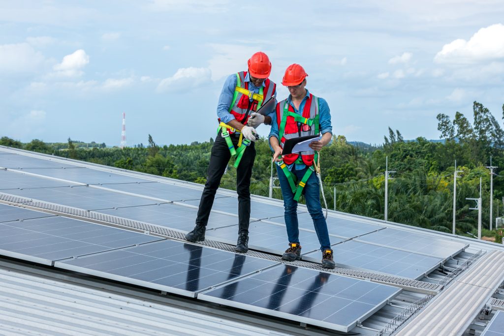 Engineers working on a solar panel during a servicing appointment